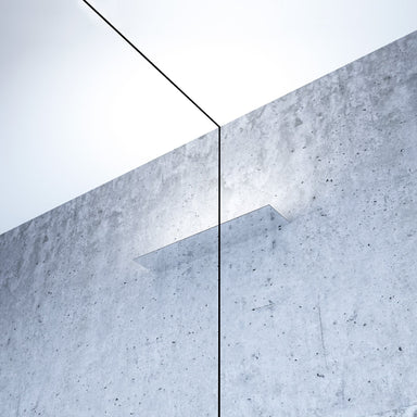 Mirror finished LED wall light on concrete wall